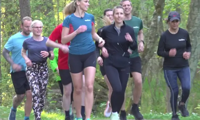 En grupp löpare njuter av en löprunda i skogen, en härlig lopp i Stockholm.